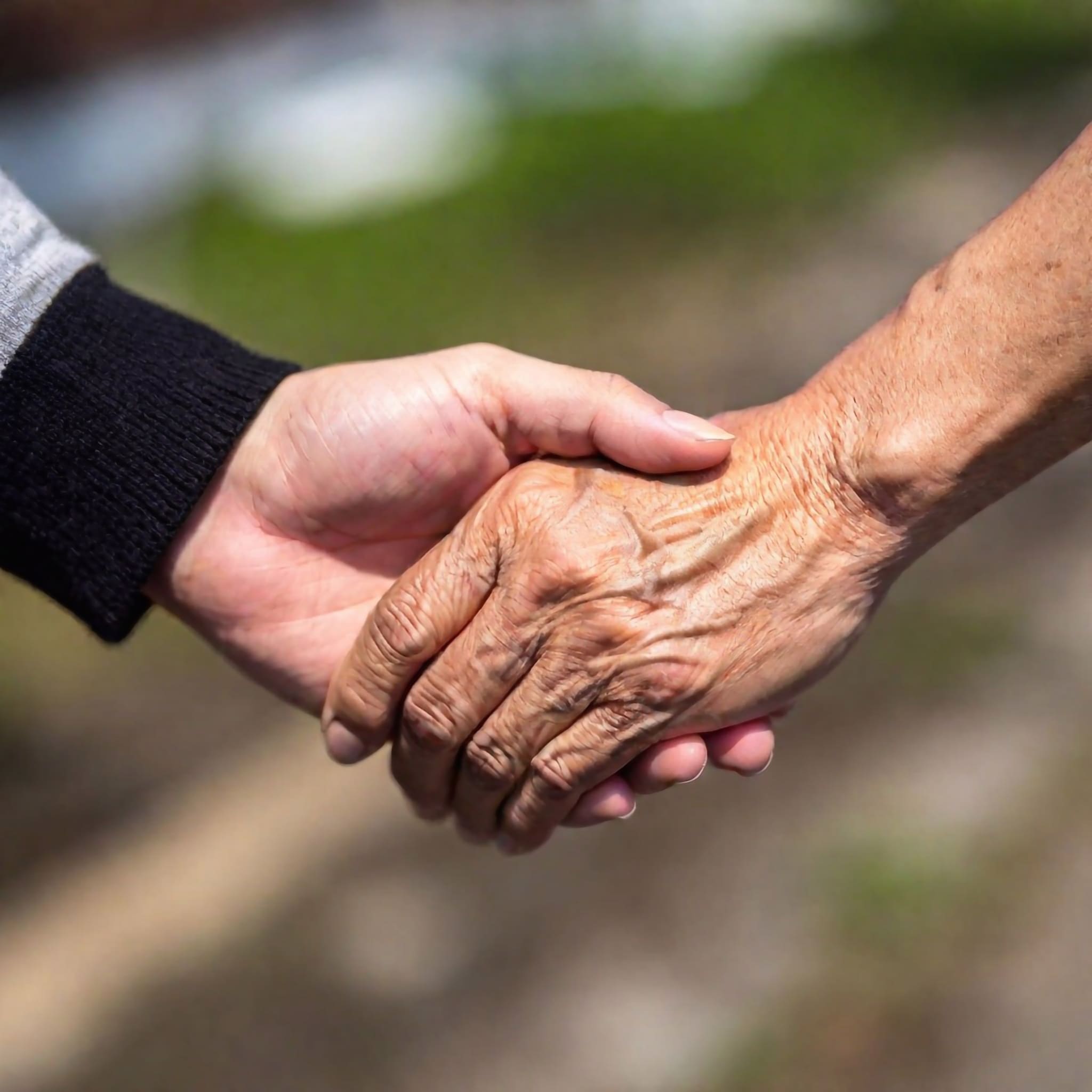 two hands holding each other